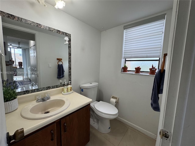 3550 Blue Lake Dr Unit 501, Pompano Beach, FL 33064 - bathroom featuring toilet, vanity, tile patterned floors, and baseboards