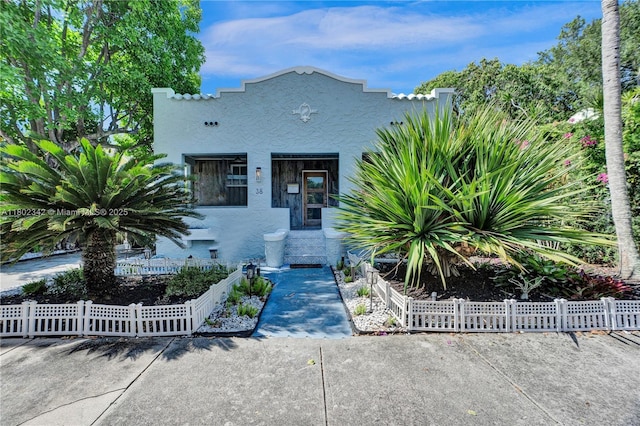 38 NW 47th Ter, Miami, FL 33127 - mediterranean / spanish house featuring stucco siding and a fenced front yard
