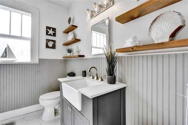 38 NW 47th Ter, Miami, FL 33127 - bathroom with wainscoting, toilet, vanity, and tile patterned floors