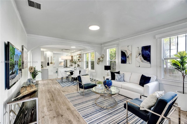 38 NW 47th Ter, Miami, FL 33127 - living area featuring crown molding, wood finished floors, and baseboards