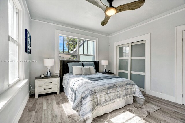 38 NW 47th Ter, Miami, FL 33127 - bedroom with light wood-type flooring, crown molding, baseboards, and a ceiling fan