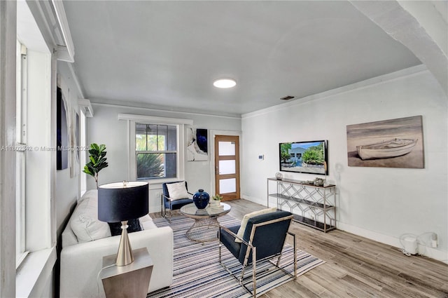 38 NW 47th Ter, Miami, FL 33127 - living room featuring ornamental molding, wood finished floors, and baseboards
