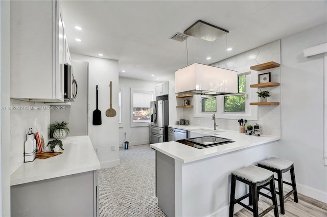 38 NW 47th Ter, Miami, FL 33127 - kitchen with open shelves, appliances with stainless steel finishes, a sink, baseboards, and recessed lighting