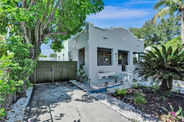 38 NW 47th Ter, Miami, FL 33127 - mediterranean / spanish home featuring stucco siding and fence