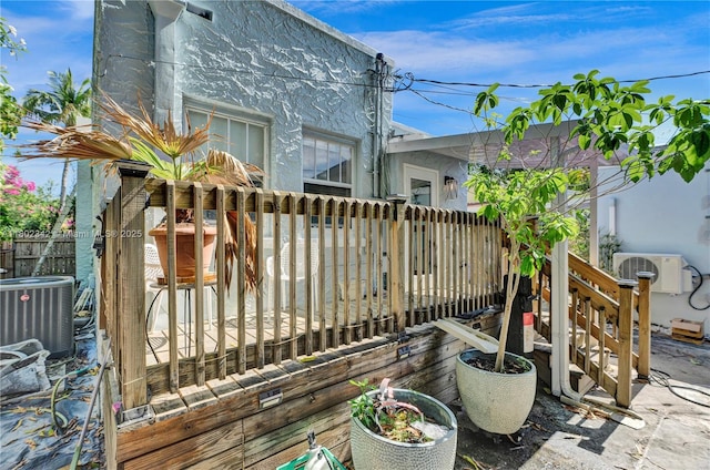 38 NW 47th Ter, Miami, FL 33127 - wooden terrace featuring central AC unit, ac unit, and fence