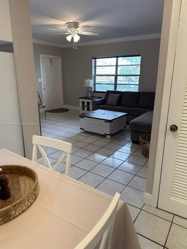 2600 S Ocean Dr Unit S113, Hollywood, FL 33019 - living room with light tile patterned floors, crown molding, ceiling fan, and baseboards