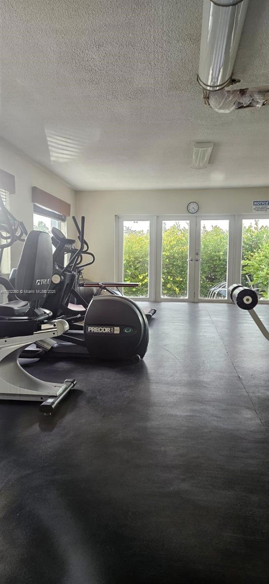 2600 S Ocean Dr Unit S113, Hollywood, FL 33019 - workout area featuring plenty of natural light, a textured ceiling, and french doors