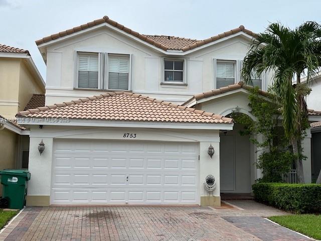 8753 SW 3rd Ln, Miami, FL 33174 - view of front facade with a tile roof, decorative driveway, and stucco siding