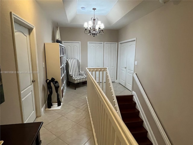 8753 SW 3rd Ln, Miami, FL 33174 - staircase featuring a tray ceiling, tile patterned flooring, and a chandelier