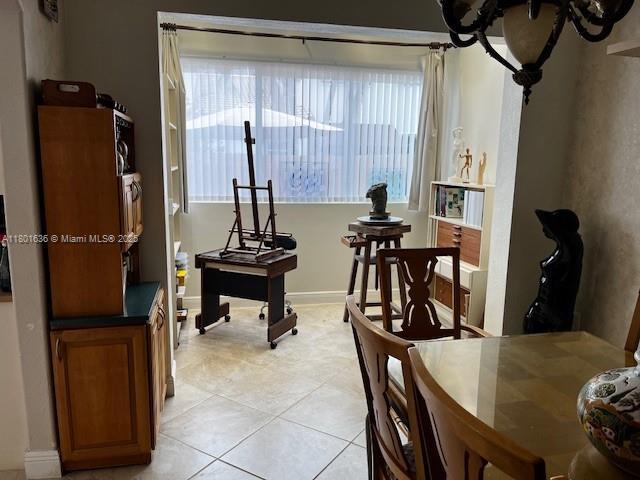 8753 SW 3rd Ln, Miami, FL 33174 - dining area with healthy amount of natural light, light tile patterned floors, and a chandelier