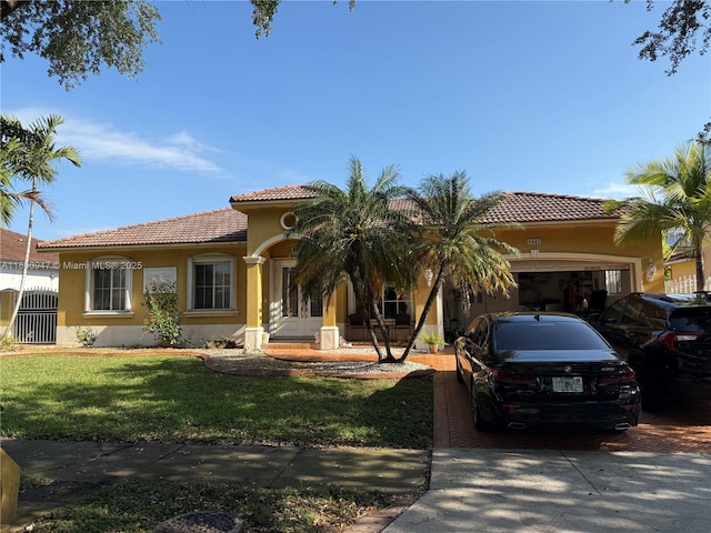 8943 NW 174th St, Hialeah, FL 33018 - mediterranean / spanish home featuring stucco siding, a garage, a tile roof, and concrete driveway