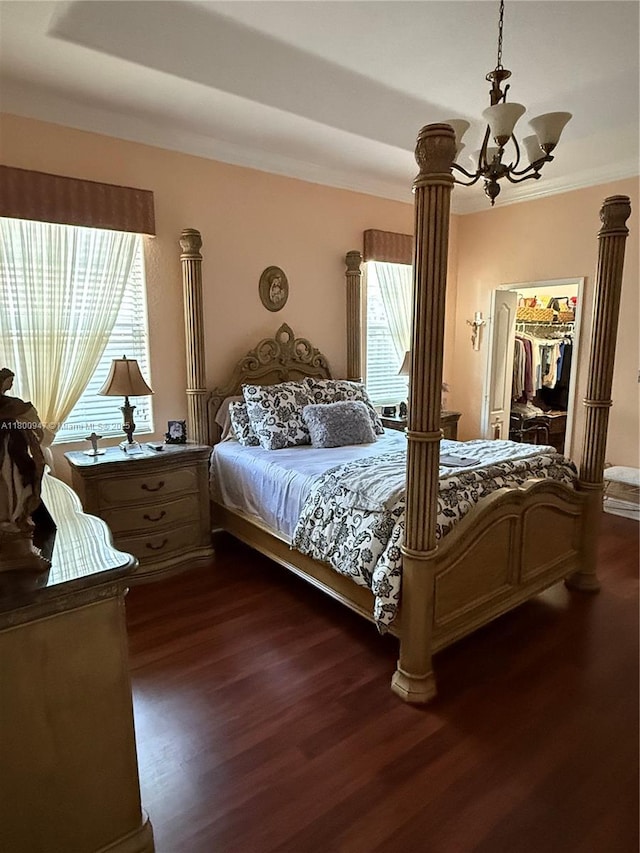 8943 NW 174th St, Hialeah, FL 33018 - bedroom featuring multiple windows, a chandelier, dark wood finished floors, ornamental molding, and a walk in closet
