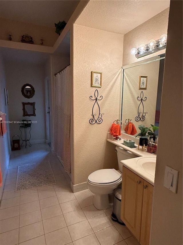 8943 NW 174th St, Hialeah, FL 33018 - bathroom with tile patterned floors, toilet, a textured wall, vanity, and a textured ceiling