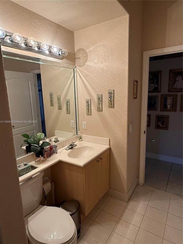 8943 NW 174th St, Hialeah, FL 33018 - half bathroom with tile patterned flooring, a textured wall, toilet, vanity, and a textured ceiling