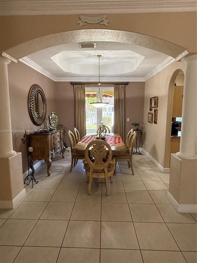 8943 NW 174th St, Hialeah, FL 33018 - dining space featuring arched walkways, a tray ceiling, baseboards, crown molding, and light tile patterned floors