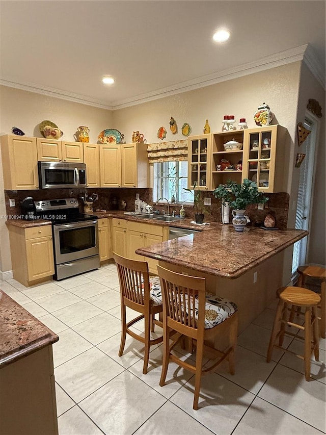 8943 NW 174th St, Hialeah, FL 33018 - kitchen with appliances with stainless steel finishes, light brown cabinets, tasteful backsplash, crown molding, and a peninsula