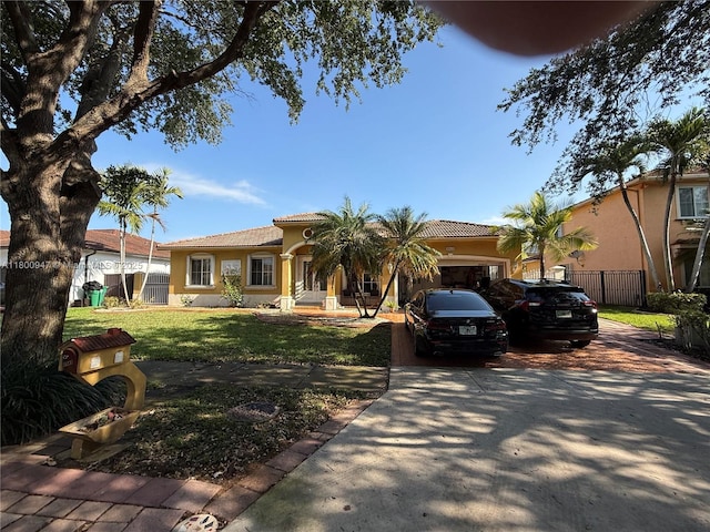 8943 NW 174th St, Hialeah, FL 33018 - mediterranean / spanish-style house featuring concrete driveway, stucco siding, a tiled roof, and a garage