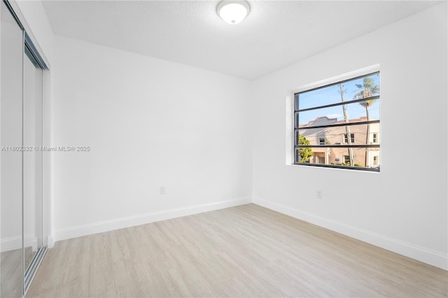 1661 SW 3rd St Unit 8, Miami, FL 33135 - unfurnished room with wood finished floors, baseboards, and a textured ceiling