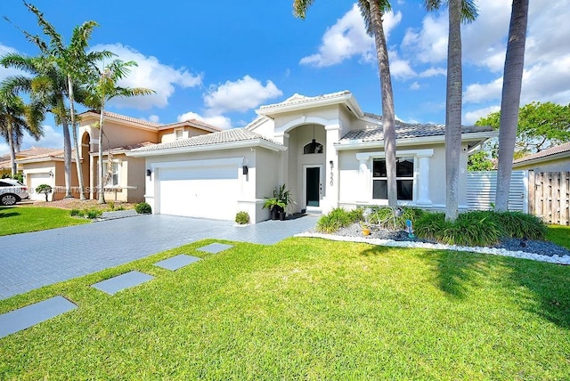 1550 SW 194th Ave, Pembroke Pines, FL 33029 - mediterranean / spanish-style home featuring stucco siding, a garage, decorative driveway, and a tile roof