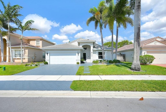 1550 SW 194th Ave, Pembroke Pines, FL 33029 - mediterranean / spanish-style house featuring an attached garage, stucco siding, decorative driveway, and a front lawn