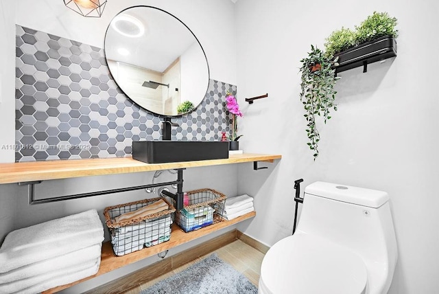 1550 SW 194th Ave, Pembroke Pines, FL 33029 - bathroom with toilet, a sink, wood finished floors, baseboards, and tiled shower