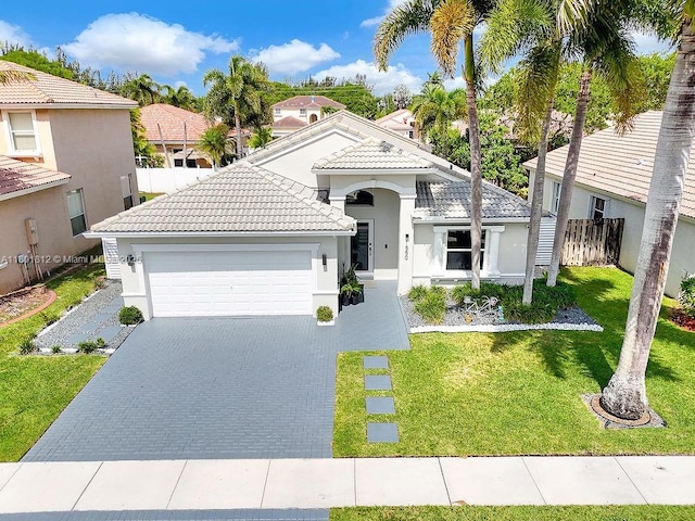 1550 SW 194th Ave, Pembroke Pines, FL 33029 - view of front facade with a garage, a tile roof, stucco siding, and decorative driveway