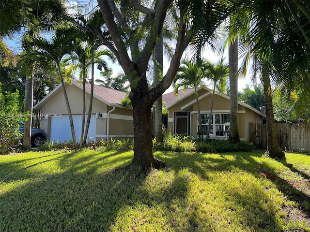 2014 SE Mantua St, Port St Lucie, FL 34952 - back of house with stucco siding and a garage