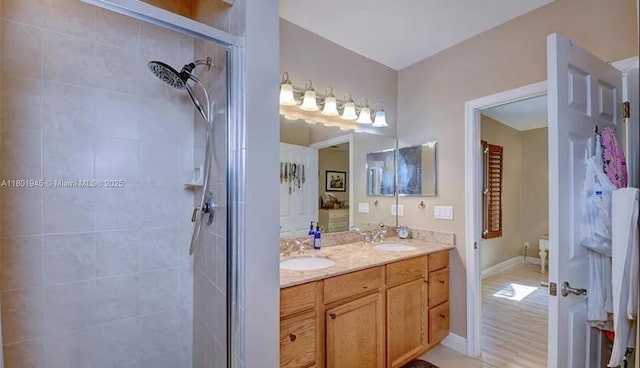 2014 SE Mantua St, Port St Lucie, FL 34952 - bathroom with a stall shower, double vanity, and baseboards