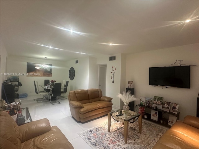 living area featuring a desk and light tile patterned flooring