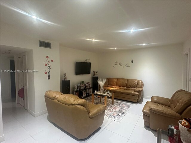 living room featuring light tile patterned floors and baseboards