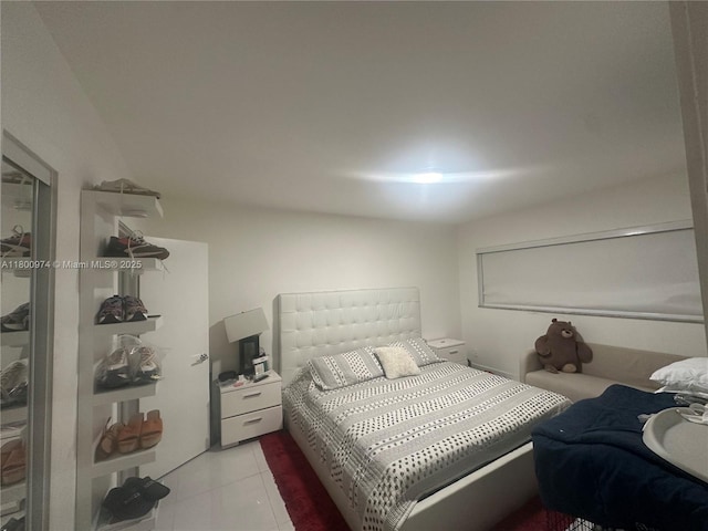 bedroom with light tile patterned floors