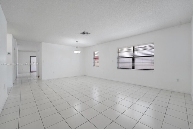 14431 SW 111th Ter, Miami, FL 33186 - unfurnished bedroom featuring two closets, a textured ceiling, and baseboards