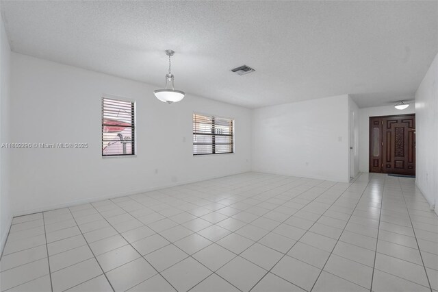 14431 SW 111th Ter, Miami, FL 33186 - unfurnished room with a textured ceiling and light tile patterned floors