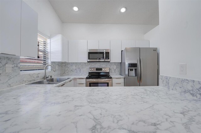 14431 SW 111th Ter, Miami, FL 33186 - kitchen with stainless steel appliances, a sink, light countertops, white cabinetry, and backsplash