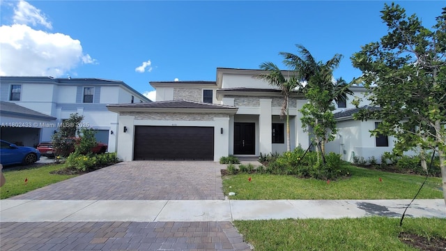 4578 SW 174th Ave, Miramar, FL 33029 - view of front of house featuring stucco siding, an attached garage, decorative driveway, stone siding, and a front lawn