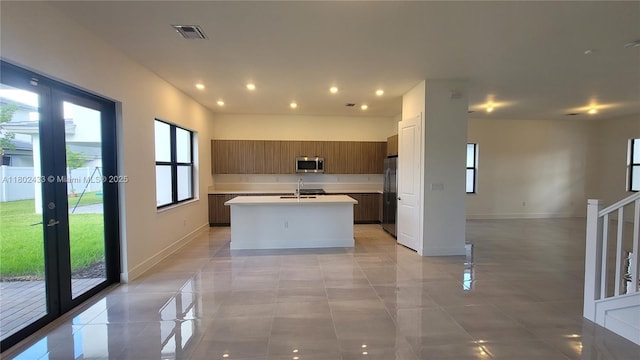 4578 SW 174th Ave, Miramar, FL 33029 - kitchen with stainless steel appliances, a center island with sink, light countertops, light tile patterned floors, and recessed lighting