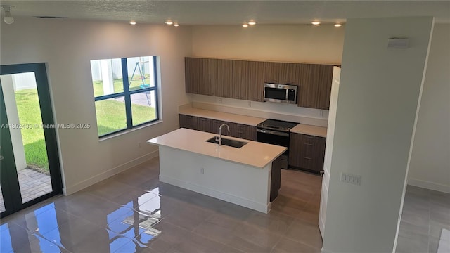 4578 SW 174th Ave, Miramar, FL 33029 - kitchen featuring appliances with stainless steel finishes, a sink, light countertops, modern cabinets, and an island with sink