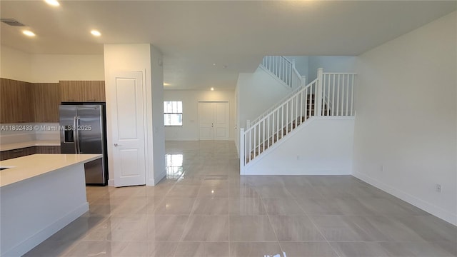 4578 SW 174th Ave, Miramar, FL 33029 - kitchen with stainless steel fridge, light countertops, brown cabinets, baseboards, and modern cabinets