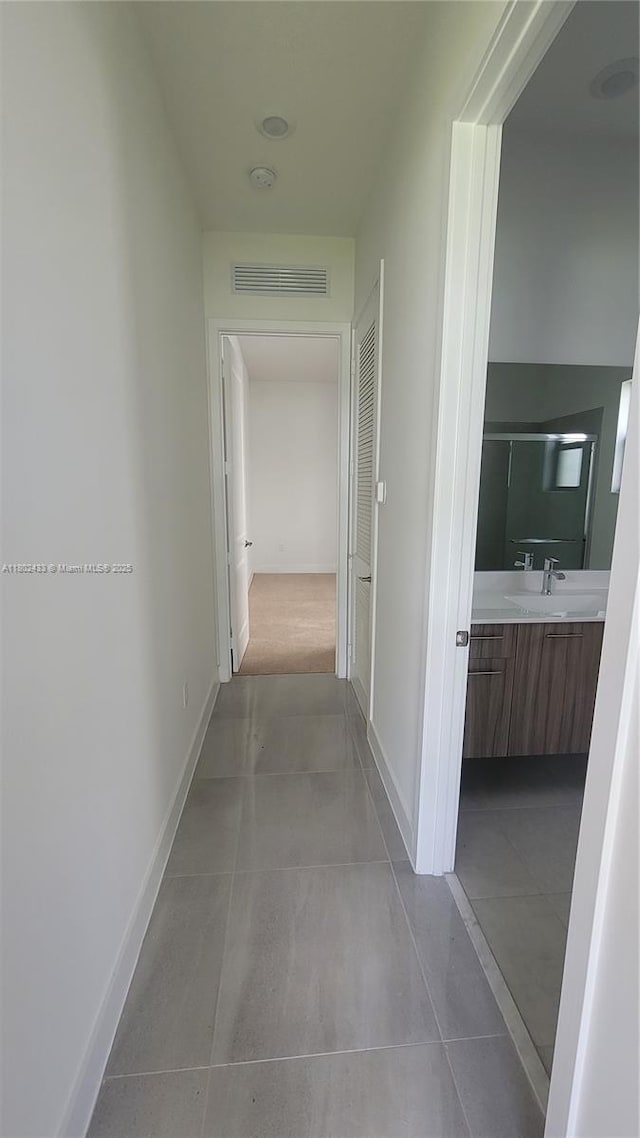 4578 SW 174th Ave, Miramar, FL 33029 - hallway featuring a sink, tile patterned flooring, and baseboards