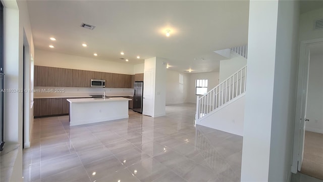 4578 SW 174th Ave, Miramar, FL 33029 - kitchen featuring appliances with stainless steel finishes, modern cabinets, light countertops, an island with sink, and recessed lighting
