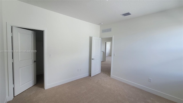 4578 SW 174th Ave, Miramar, FL 33029 - unfurnished bedroom featuring light carpet, baseboards, and a textured ceiling
