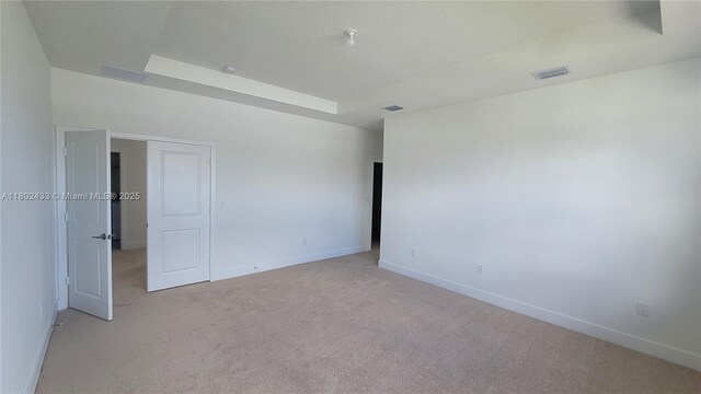 4578 SW 174th Ave, Miramar, FL 33029 - spare room featuring light colored carpet, baseboards, and a tray ceiling