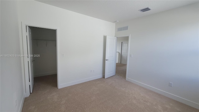4578 SW 174th Ave, Miramar, FL 33029 - unfurnished bedroom with a spacious closet, light carpet, baseboards, and a closet