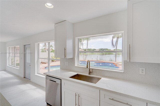 6381 Willoughby Cir, Lake Worth, FL 33463 - kitchen featuring stainless steel dishwasher, a sink, white cabinets, tasteful backsplash, and recessed lighting