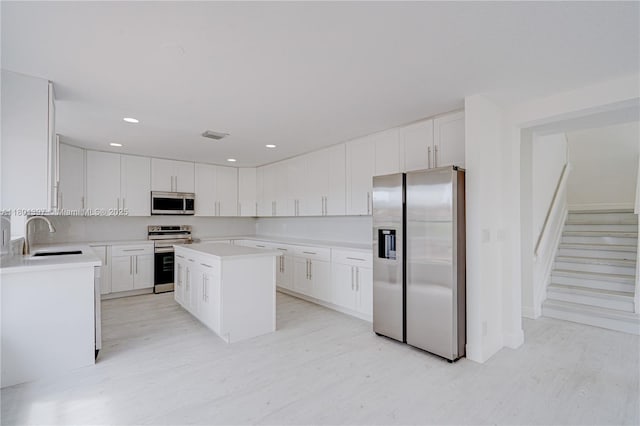 6381 Willoughby Cir, Lake Worth, FL 33463 - kitchen featuring appliances with stainless steel finishes, a sink, light countertops, white cabinets, and recessed lighting