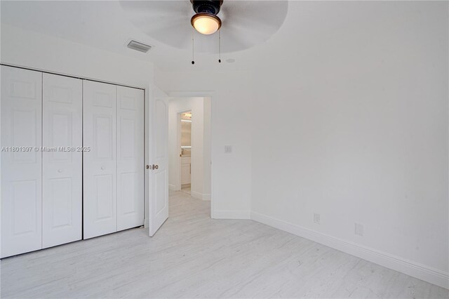 6381 Willoughby Cir, Lake Worth, FL 33463 - unfurnished bedroom with a closet, baseboards, ceiling fan, and light wood-style floors