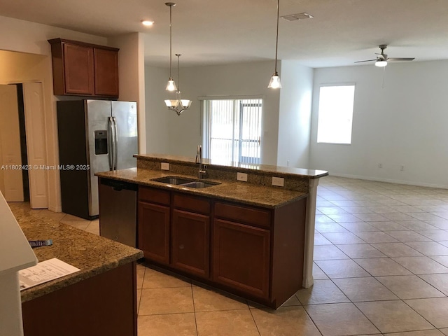 3319 Rodrick Cir, Orlando, FL 32824 - kitchen with a sink, appliances with stainless steel finishes, light tile patterned floors, dark stone counters, and recessed lighting