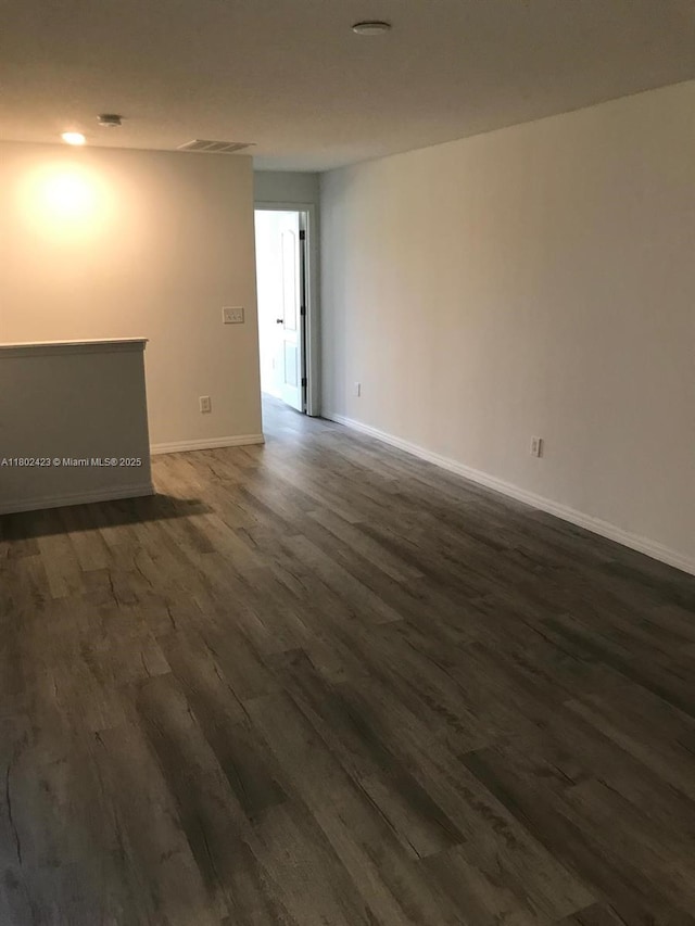 3319 Rodrick Cir, Orlando, FL 32824 - empty room with dark wood-style floors and baseboards