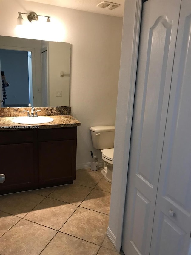 3319 Rodrick Cir, Orlando, FL 32824 - half bath with tile patterned flooring, toilet, vanity, and baseboards