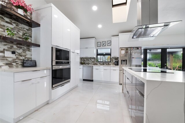 8840 SW 181st Ter, Palmetto Bay, FL 33157 - kitchen featuring appliances with stainless steel finishes, island range hood, modern cabinets, backsplash, and open shelves